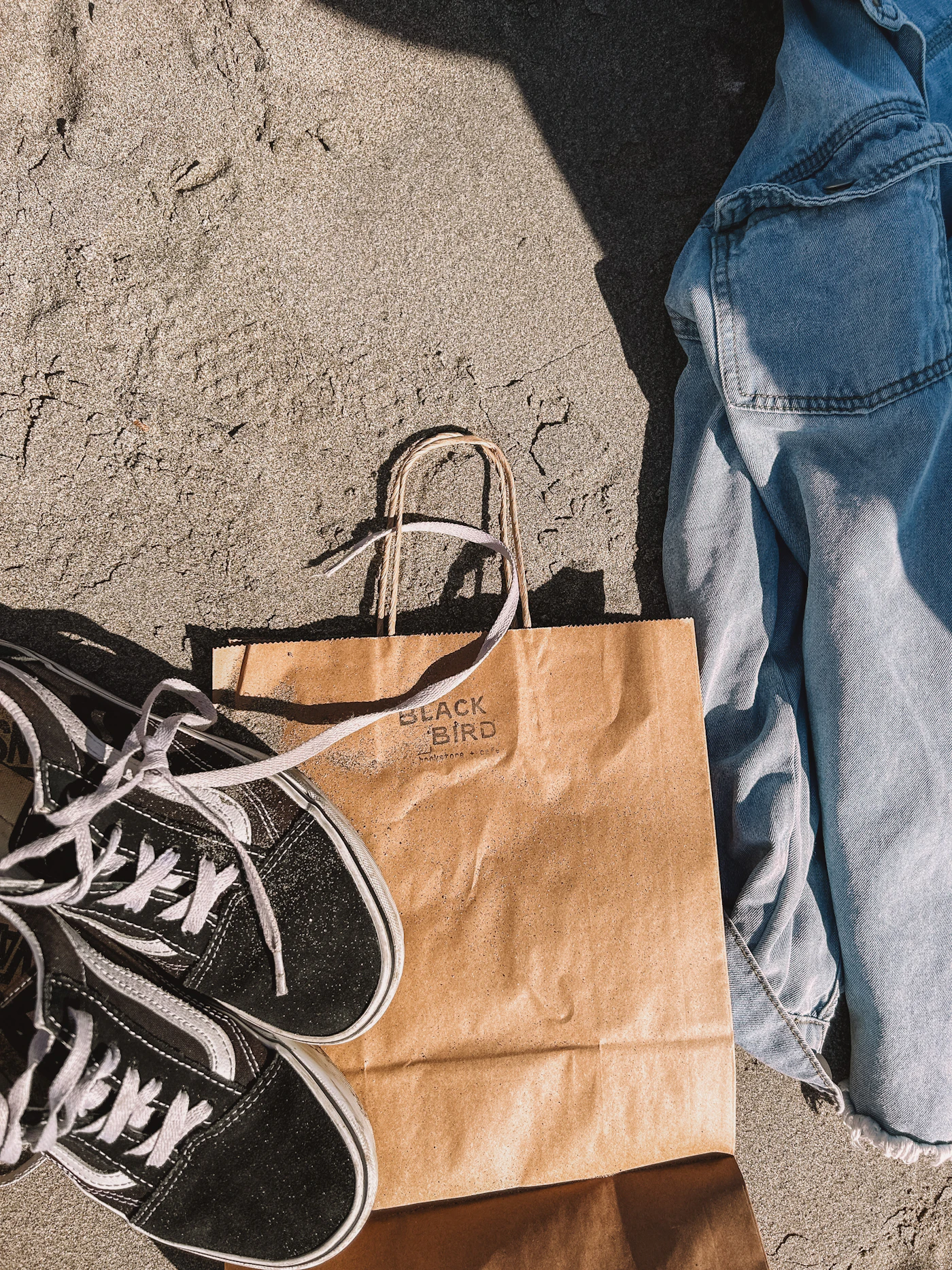 A pair of shoes and a bag on the ground