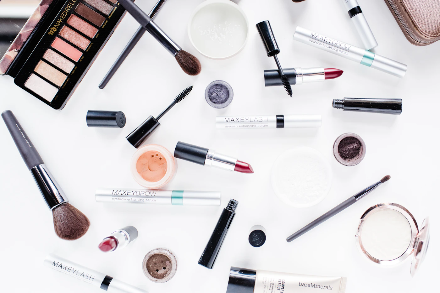 Makeup brushes and cosmetics on a white table