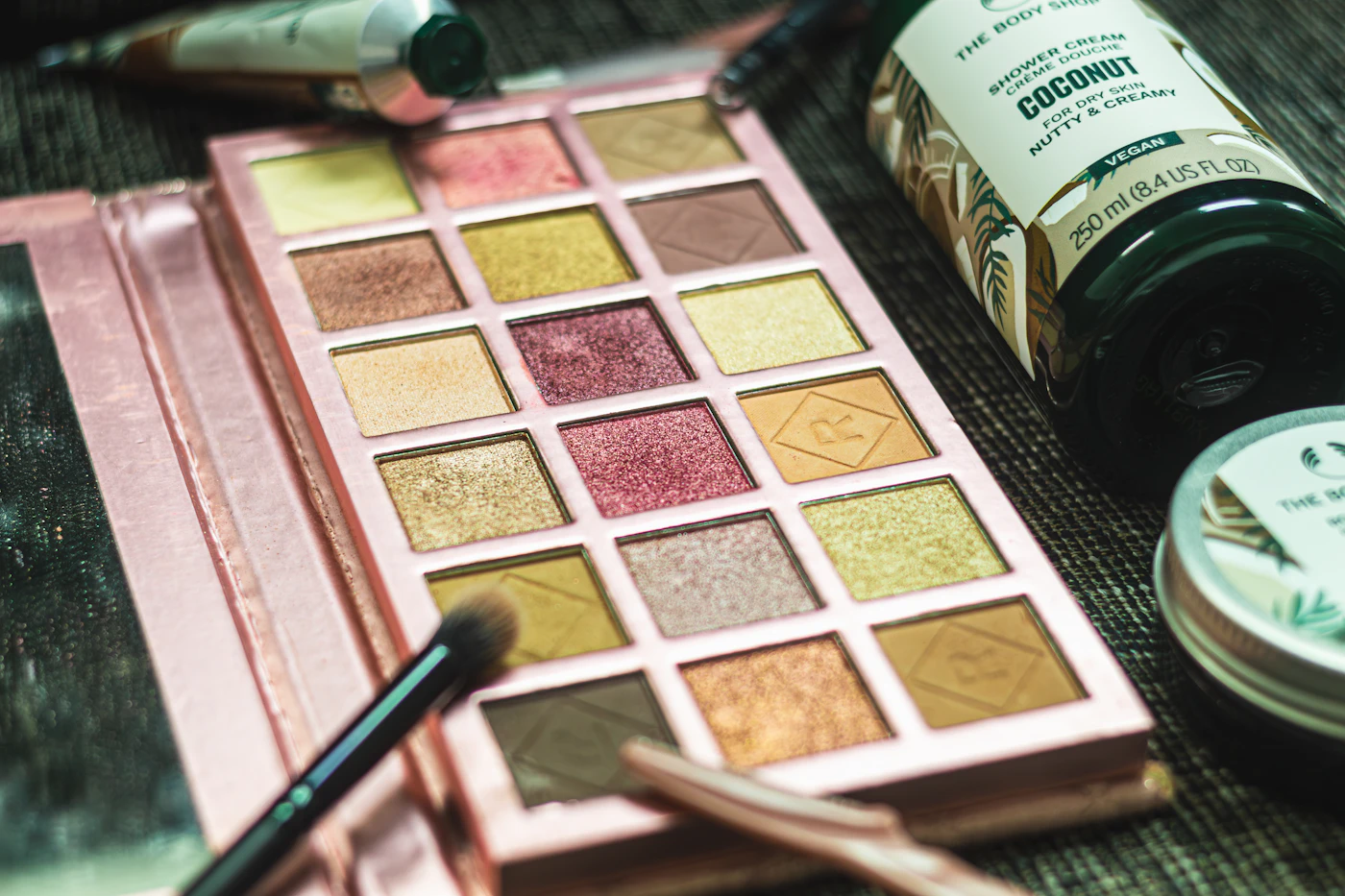 A close up of a table with cosmetics and a brush