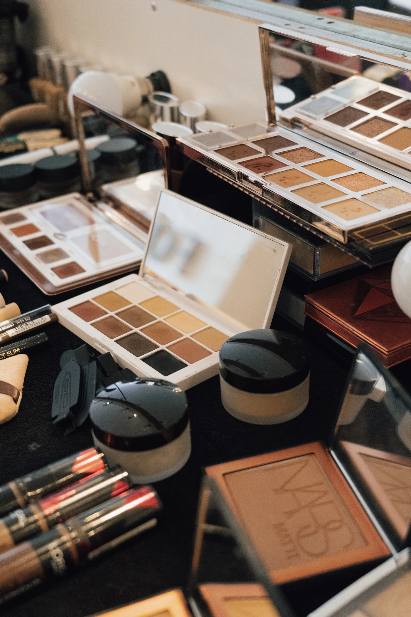 Assortment of makeup palettes and products on a table